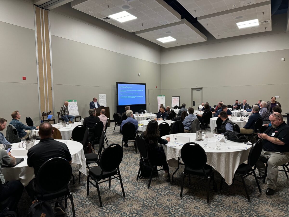 Group of people meeting for the NW Heat Pump Symposium