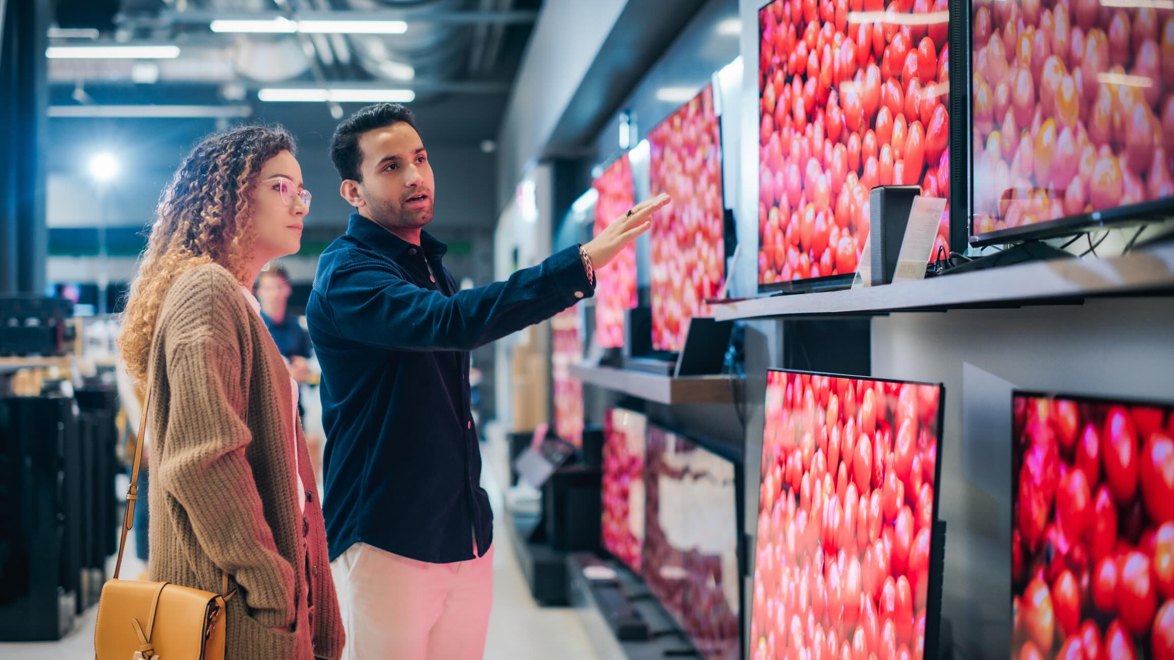 People TV Shopping at Retail Electronics Store