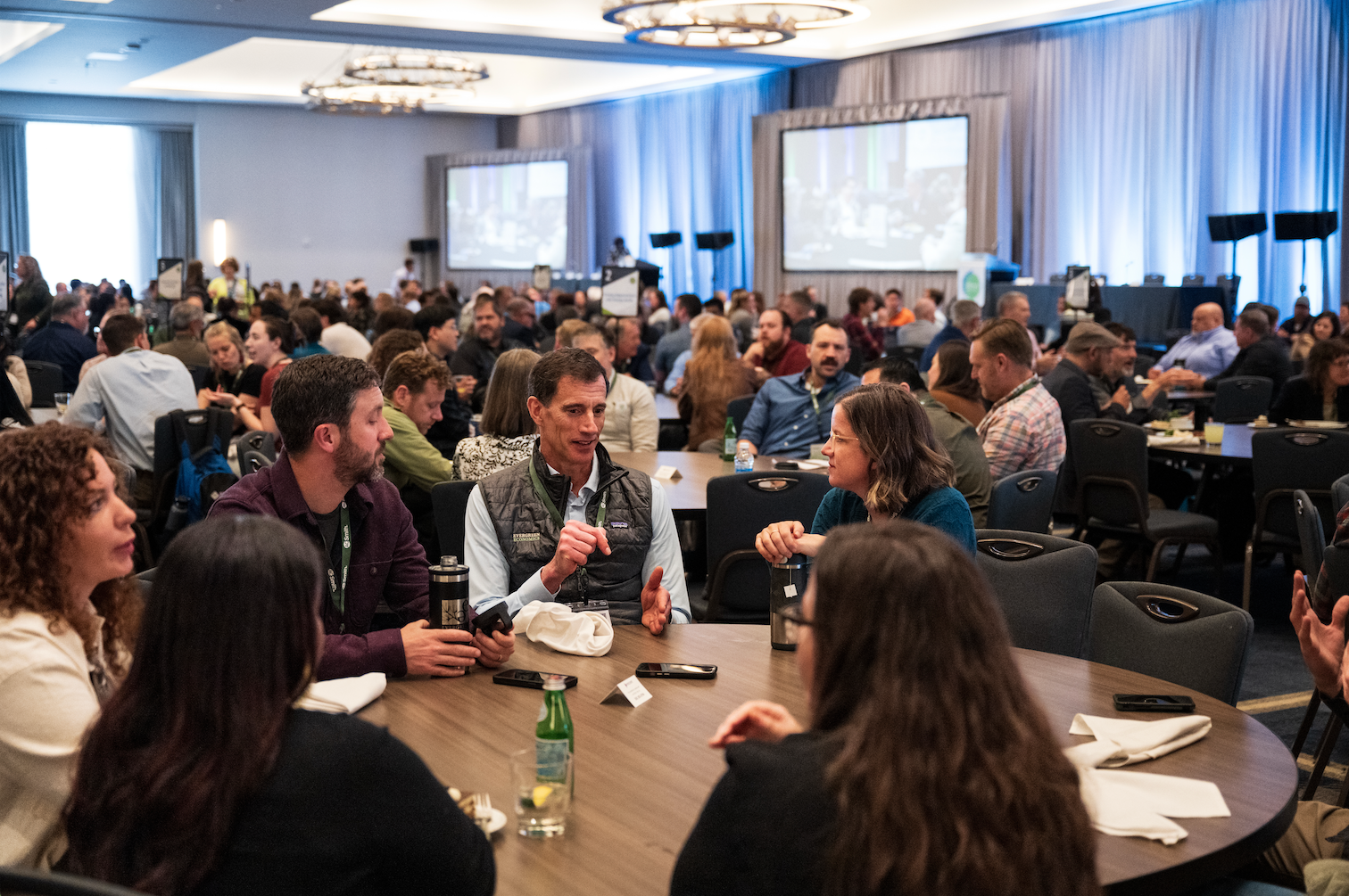 people collaborating at tables at efficiency exchange